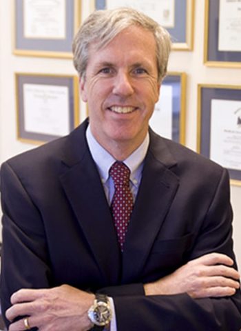 A Man Wearing A Suit And Tie